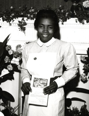 A proud young nurse with her certificate | by Photo-Reportage Ltd.