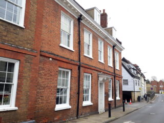 Colour photo of street with 18th century brick buildings | Susan Payne