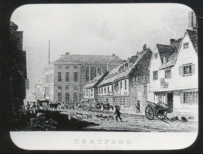 This engraving of Fore Street was published in 1823 by Sherwood & Co. The building on the far right is the Cross Keys Inn and next to it is the gaol which was later replaced by the two Corn Exchanges. You can see there is no clock on the Shire Hall at this time - it was added in 1824. Originally all animals brought to market were sold in this street. In 1851 a new market place was opened behind the Ram Inn. | Hertfordshire Archives and Local Studies/Mr Elsden