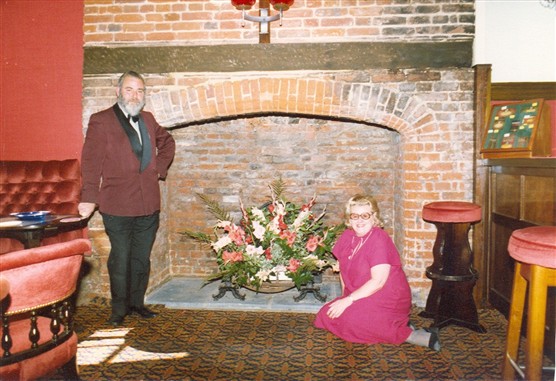 Gerry and Kathie Marsh in front of the newly discovered fireplace