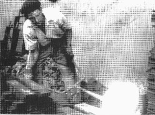 Black and white photograph of man working with molten metal