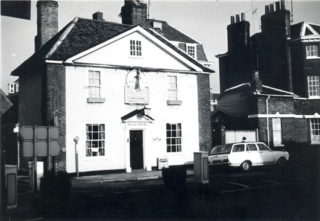 Black and white photograph of a building on an urban street | Hertfordshire Archives and Local Studies